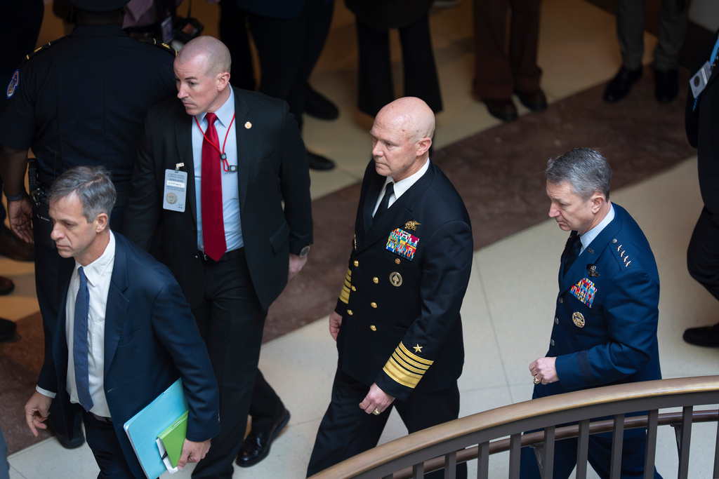 U.S. Navy Adm. Frank "Mitch" Bradley, center, commander of the U.S. Special Operations Command, and Gen. Dan Caine, chairman of the Joint Chiefs of Staff, right, are escorted to a classified briefing for top congressional lawmakers overseeing national security as they investigate how Defense Secretary Pete Hegseth handled a military strike on a suspected drug smuggling boat and its crew in the Caribbean near Venezuela Sept. 2, at the Capitol in Washington on Dec. 4, 2025. (Photo by J. Scott Applewhite / AP)